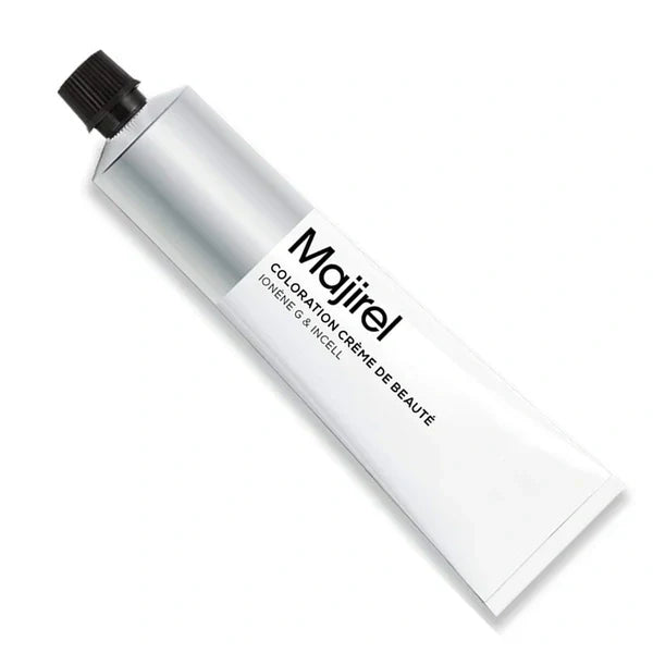 Professional stylist applying Majirel 5.52 on client